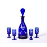 Bristol blue glass decanter and four glasses painted in enamels with swags of flowers, decanter 34.