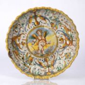 Maiolica dish Italian, circa 1800, with central cupid within a border of arabesques, 24cm