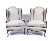 Pair of French style wing armchairs each with grey upholstery and matching loose squab cushions,