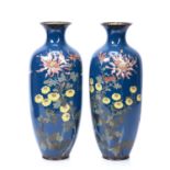 Pair of Japanese cloisonne enamel vases with bird amongst foliage designs on blue ground, 37cm