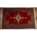 Red ground rug with central foliate design and blue floral border, 123cm x 198cmCondition report: At