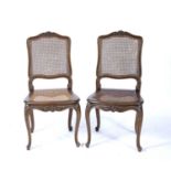 Pair of French style stained beech side chairs each with cane seat and back and carved frames,