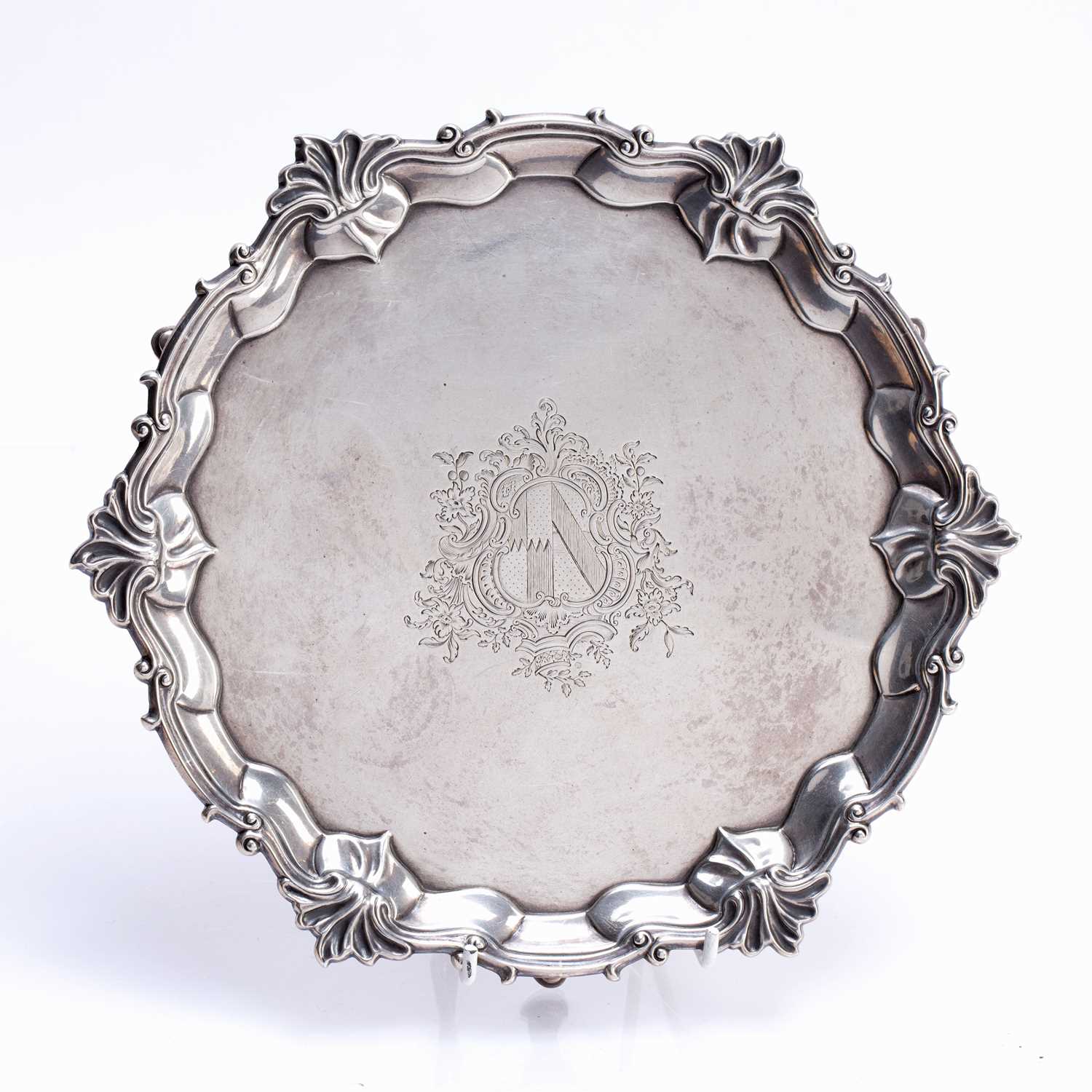 Matched pair of silver trays one a George IV silver tray, with shaped edges standing on three pad