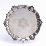 Matched pair of silver trays one a George IV silver tray, with shaped edges standing on three pad
