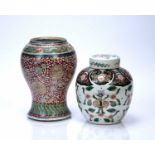 Two Chinese vases 18th/19th Century, to include a coral red ground baluster vase with foliate