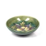 Moorcroft pottery 'Columbine' pattern bowl on green ground, impressed marks to the base, 24cm