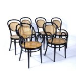 Set of six ebonised bentwood dining chairs in the manner of Thonet, each with caned seat and back,