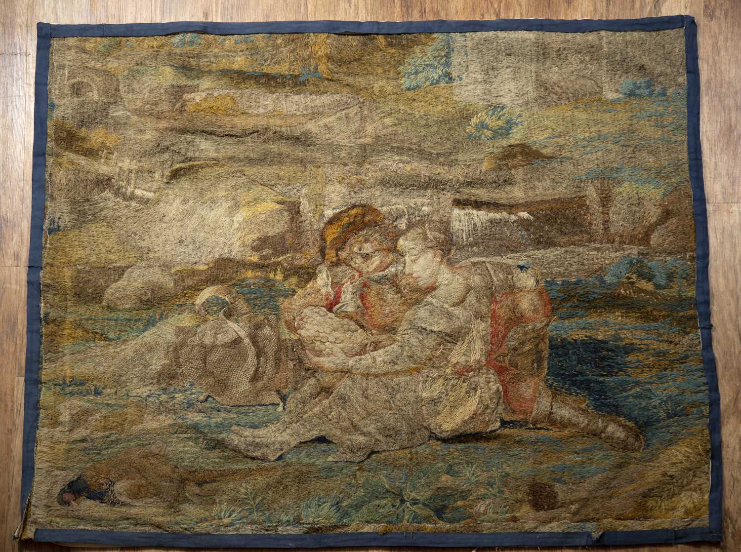 Flemish tapestry 18th Century, depicting a lake landscape with lovers holding a bowl of fruit, 150cm