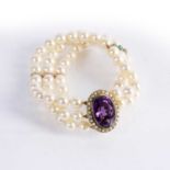 Three strand pearl bracelet with amethyst clasp mounted in yellow precious metal surrounded by