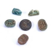 Collection of pieces consisting of an Islamic metal coin, three miniature scarabs and two small