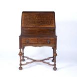 Walnut bureau Queen Anne style, with cupboard and open shelves enclosed by a fall flap and with