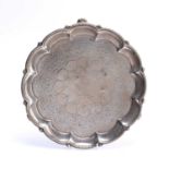 Victorian silver tray with shaped edge standing on three feet, heavily engraved, bearing marks for