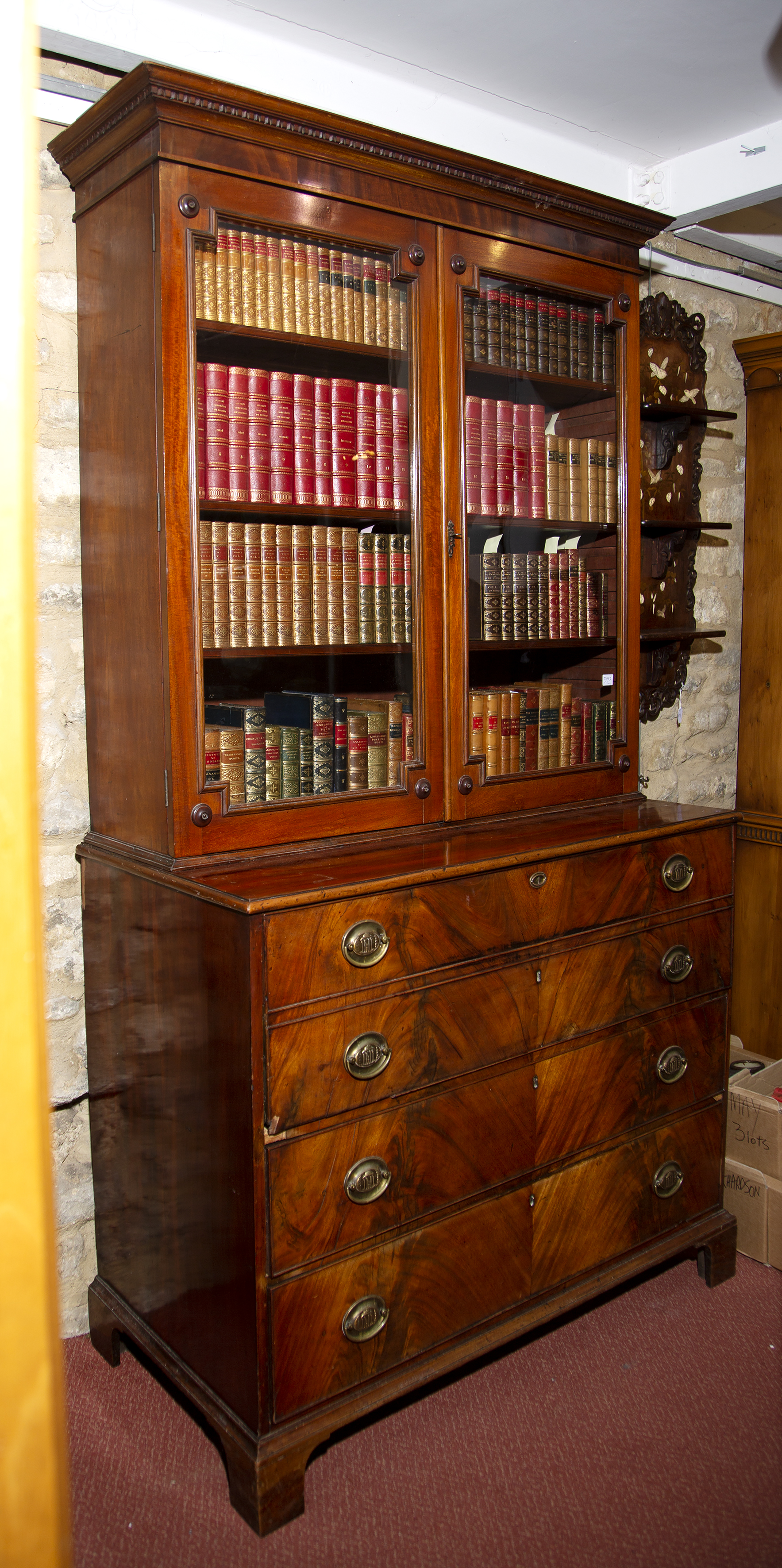 A George III mahogany secretaire, with fitted interior and panelled as two drawers, with two further