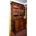 A George III mahogany secretaire, with fitted interior and panelled as two drawers, with two further