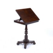 An early Victorian mahogany reading table, the rectangular hinged top with rounded corners and