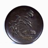 A Japanese circular bronze plaque with raised water bird and bullrush decoration, seal mark verso