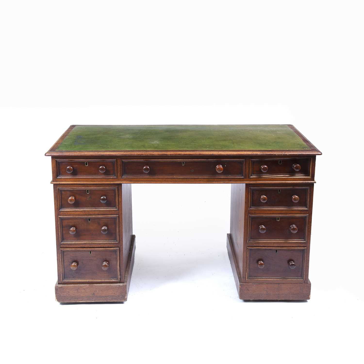 A Victorian mahogany pedestal desk, the top with morocco leather inset above one long and eight