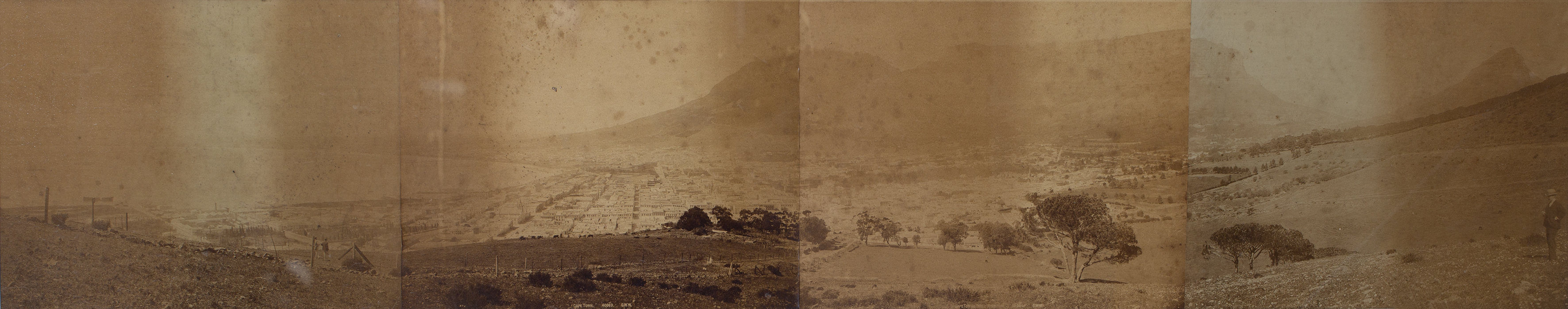 A panoramic framed photograph view of Cape Town c1900, four images glued down and framed, 112 x