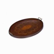 An Edwardian oval mahogany tea tray inlaid with paterae, fan medallion and ribbon tied festoons of