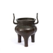 A Chinese 18th Century bronze tripod censer, with looped handles and lobed body, 24cm high