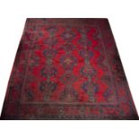 An old Turkey Oushak carpet with repeating blue and green medallion motif on a red ground, 365 x
