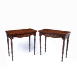 A pair of Victorian mahogany fold over top card tables, the tops inlaid with scrolling and flowering