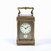 A late 19th century French brass carriage clock, with circular enamel dial above a subsidiary