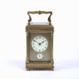 A late 19th century French brass carriage clock, with circular enamel dial above a subsidiary