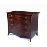 A George III serpentine fronted mahogany chest, the top with a narrow crossband above four graduated