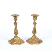 A pair of 19th century French gilt metal candlesticks, cast with insects and stylised foliage, on