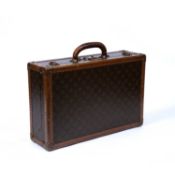 A vintage Louis Vuitton monogram small suitcase, with stamped brass lock and clasps, label to the