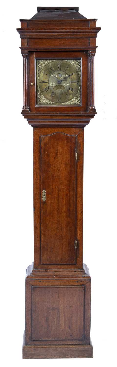 A George III oak longcase clock, the hood with caddy top and turned pillars, the brass dial with