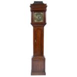 A George III oak longcase clock, the hood with caddy top and turned pillars, the brass dial with