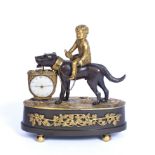 An early 19th century French bronze and gilt desk clock in the form of a boy seated on a large dog