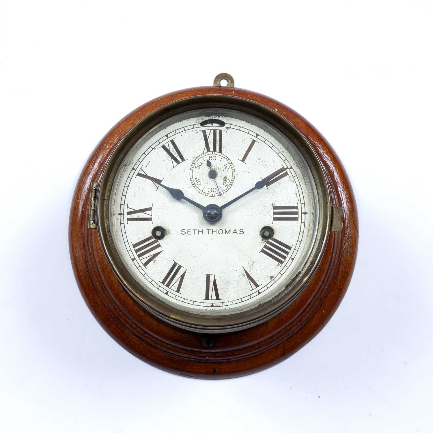 A late 19th century American nickel plated brass ship's clock, by Seth Thomas, the silvered dial