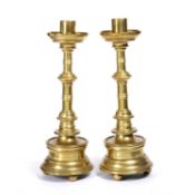 A pair of 16th Century German or south Netherlandish brass candlesticks, turned columns on ball feet