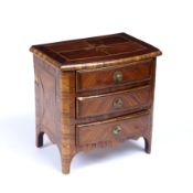 A 19th century French Kingwood veneered and inlaid miniature commode chest of three drawers, on
