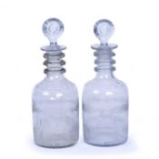 A pair of early 19th century Irish mould blown triple ring neck decanters and stoppers, by the