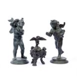 After Fernando de Luca, a bronze figure of a winged cherub holding a dolphin and companion figure of