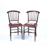 A pair of early 19th century simulated rosewood parlour chairs, the crestings with scroll and