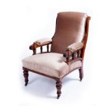 A late Victorian walnut frame armchair with turned legs and arm supports upholstered in brown