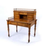 A 19th century Continental elm bonheur du jour, the raised back with a balustrade gallery above