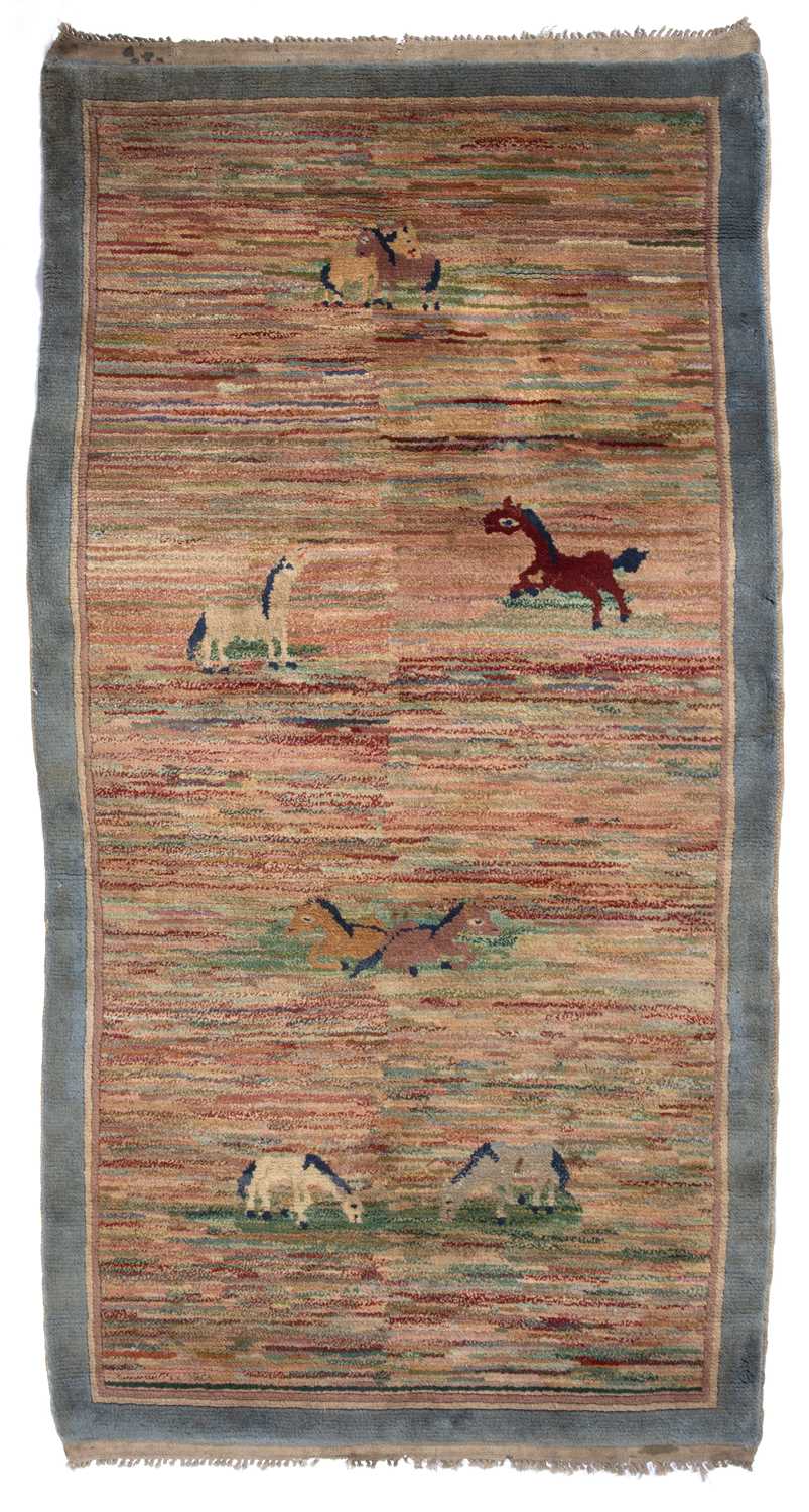 A Chinese multi-coloured pictorial rug decorated eight horses within a pastel blue border, 166 x