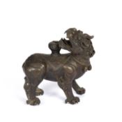 A Chinese early bronze censer in the form of a mythical beast, the head turning backwards with