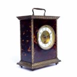 A 19th century French tortoiseshell and gilt metal mounted mantel timepiece with white enamel dial