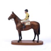 A Beswick figure of the racehorse Arkle, with Jockey Pat Taaffe up, on oval wooden plinth base, 31cm