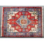 A Middle Eastern red, blue and white ground rug with geometric decoration, 143cm x 105cmCondition