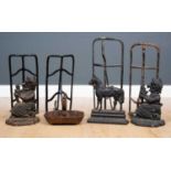 A group of four various black painted cast and wrought iron saddle racks, the largest 56cm long