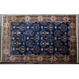 An Eastern blue ground carpet with geometric foliate decoration, 290cm x 198cmCondition report: In