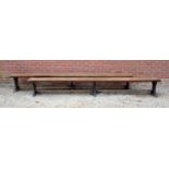 A pair of Victorian oak long benches with outset octagonal decorative columns to the shaped supports